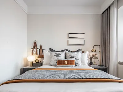 Modern minimalist bedroom with a bed, nightstands, and decorative elements.