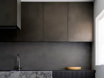 Modern minimalist kitchen featuring concrete countertops and cabinets.