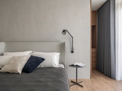 Bedroom with modern design elements featuring a neutral color palette and minimalistic style.