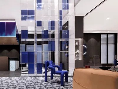 A modern hotel lobby featuring glass and metal elements.