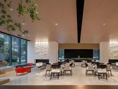 Modern hotel lobby with marble flooring, contemporary furniture, and minimalist design.