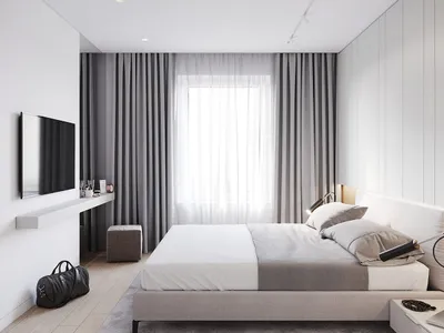 Modern minimalist bedroom with grey and white furnishings, grey curtains, and white bedding.