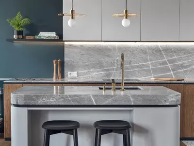 A modern residential kitchen featuring a marble countertop in a minimalist design.