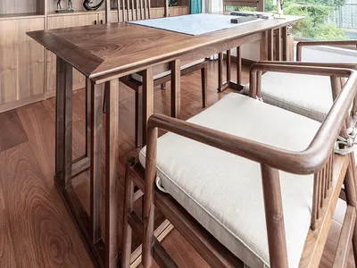 A modern home office featuring wooden furniture and a large window.