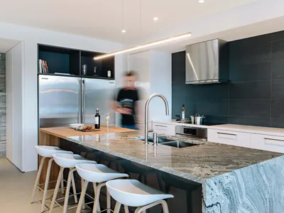 Modern kitchen featuring a sleek, luxurious countertop crafted from high-quality quartzite.