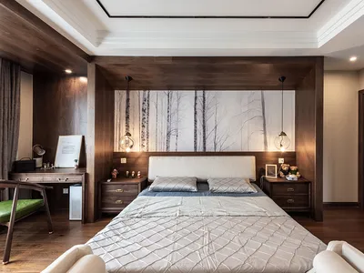A minimalist bedroom with wooden furniture, white bedding, and a forest mural