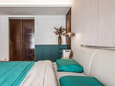 A modern bedroom featuring a fabric bed with wood and metal accents.