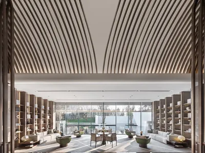 A contemporary minimalist hotel lounge featuring modern furniture and a sleek design.