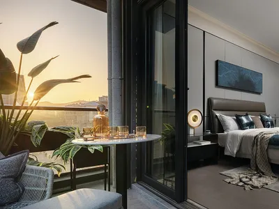 A modern bedroom with a balcony featuring a tropical plant.