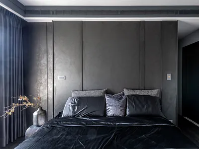 Modern bedroom featuring upholstered furniture with leather and fabric finishes.
