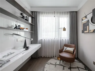 A modern home office with minimalist furniture and a comfortable armchair.