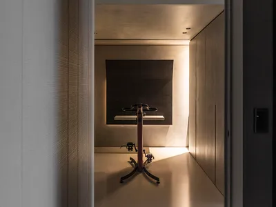 Modern home office designed with minimalist style, featuring a metal and concrete desk.