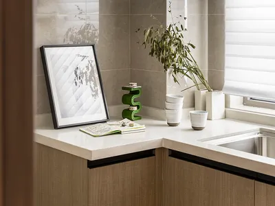 Modern minimalist kitchen featuring ceramic tiles and wooden cabinets