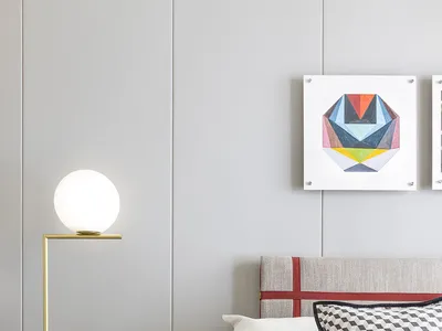 A modern minimalist bedroom with a white and red bed, a white vase with flowers on a black marble table, a spherical floor la