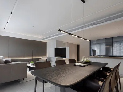 A modern living space featuring a combination of light wood, dark wood, and black materials.