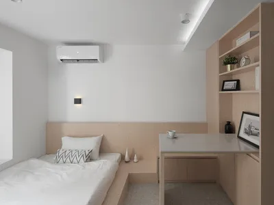 Modern minimalist bedroom featuring a wooden shelf and desk, white bedding, and a clean, uncluttered design.