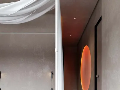 A modern minimalist bedroom featuring a white bed canopy, herringbone wood floor, and a round orange light fixture on the bei