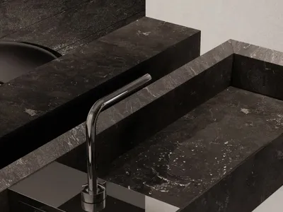A modern luxury kitchen with a marble countertop and sink.