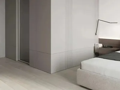 Modern minimalist bedroom featuring metallic accents and clean lines.