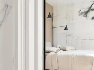 A modern minimalist bedroom featuring marble and wood materials, with a large bed and floating nightstands.