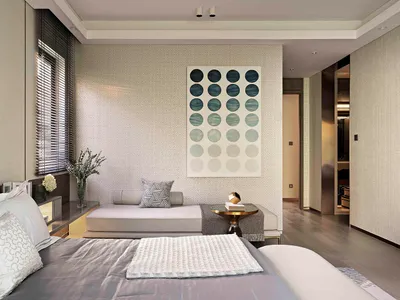 A modern minimalist bedroom with a botanical theme, showcasing neutral tones and a geometric circle pattern on the wall.