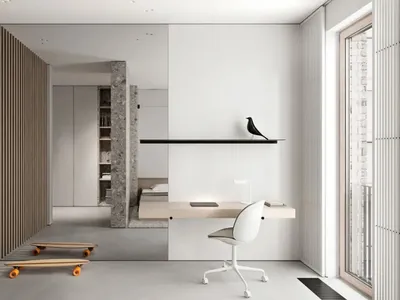 Modern minimalist bedroom featuring concrete walls and a simple floating desk with a black bird statue and a white chair.