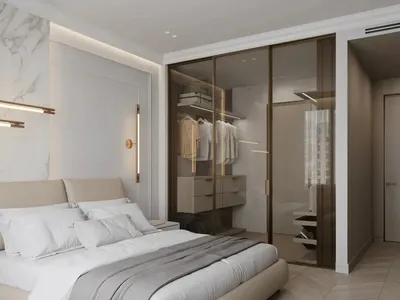 Modern bathroom with marble walls, glass shower, and wood accents