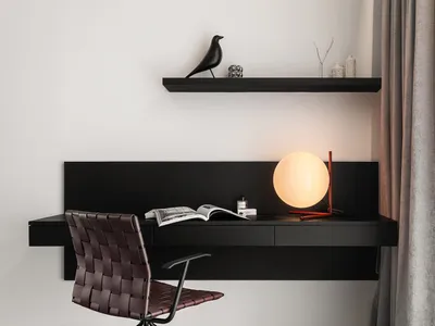 A modern black wood home office setup with a leather chair, minimalist desk, and green plant.