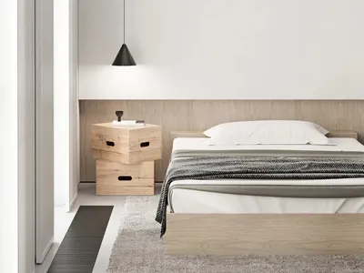 Modern minimalist bedroom with a bed, nightstand, and pendant light.
