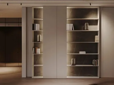 A minimalist living room with concrete interiors, featuring a bookshelf.