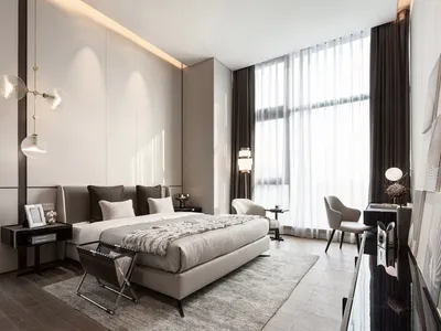 A modern bedroom featuring a bed with light wood furniture and a large window with sheer curtains.