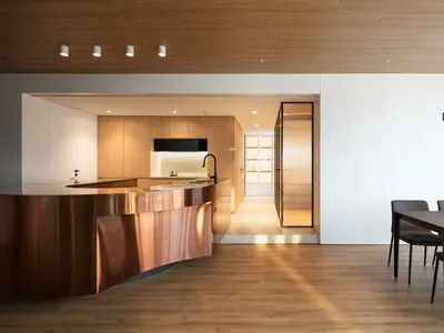 A modern kitchen with wooden panels and a sleek, minimalist design.