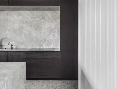 Modern kitchen featuring marble countertops and floor tiles
