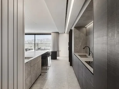 Modern kitchen with industrial design features, showcasing sleek marble countertops and minimalist aesthetic.