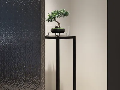 A minimalist bedroom featuring a matte black stone accent wall.
