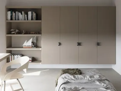 Modern bedroom with neutral tones, minimalistic style, and integrated storage units.