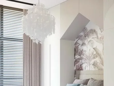 Modern bedroom interior featuring a white fabric bed, glass chandelier, and palm leaf wallpaper.