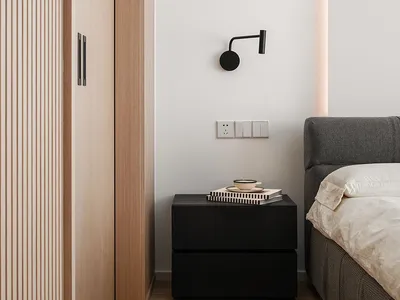 Modern minimalist bedroom featuring dark wood furniture, a gray bed, and a wall-mounted light fixture.