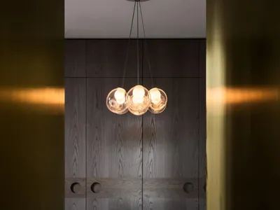 A modern kitchen featuring sleek wood paneling and a minimalist design.