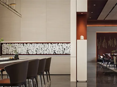 Modern restaurant interior featuring wooden furniture, marble counter, and metal accents.