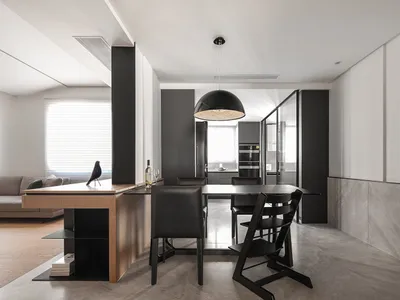 Modern minimalist kitchen with a breakfast bar made of wood and metal materials.