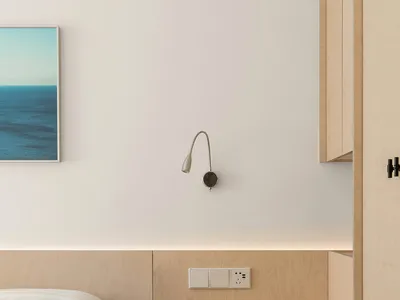 A modern minimalist bedroom featuring wooden furniture and a light blue artwork.