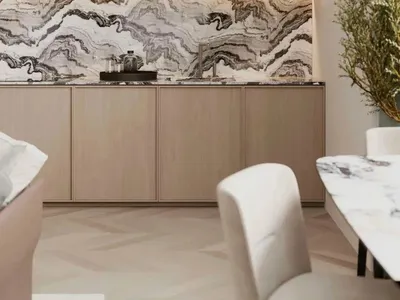 Modern kitchen with marble countertops and backsplash, wooden cabinets, and white seating.