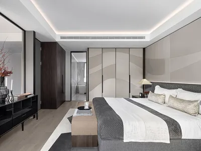 A modern minimalist bedroom featuring neutral-toned materials and sleek design elements.