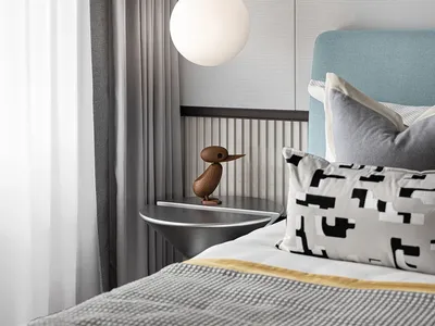 Modern bedroom interior with light fixture, textile bedding, and abstract artwork