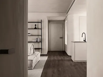 Modern minimalist kitchen with concrete finishes and dark wood flooring.