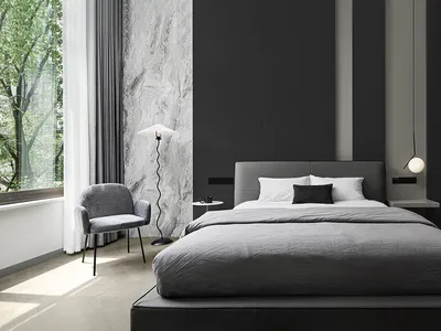 A minimalist bedroom with a fabric bed and marble accent wall