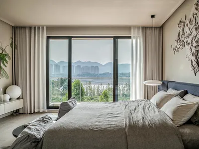 A minimalist bedroom with neutral colored furniture and decor.