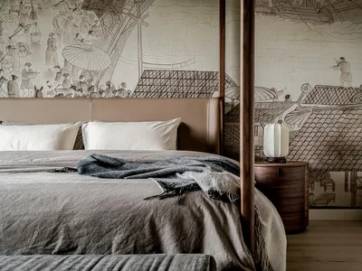 A modern bedroom featuring a fabric mural with intricate designs and a four-poster bed.