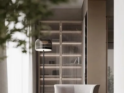 Modern minimalist living room featuring textured upholstery, a sleek floor lamp, and a small glass table with books.